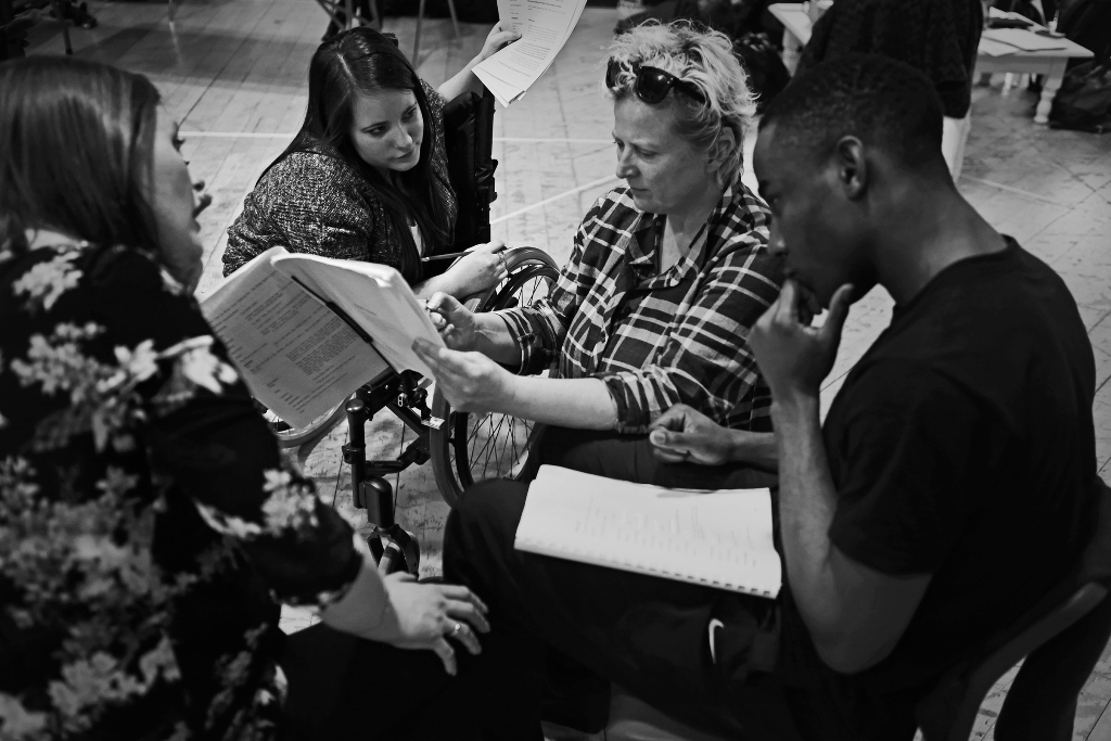 Jenny Sealey sits amongst the cast of Blood Wedding at rehearsal.