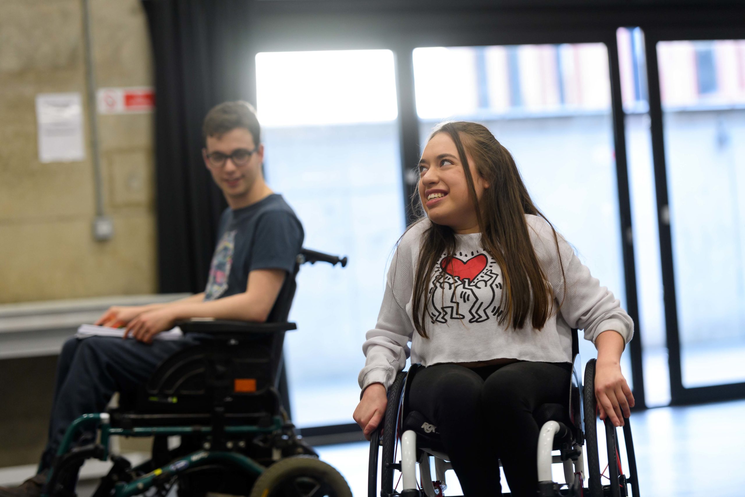 Jack Hunter & Maya Coates in rehearsals. They are smiling at each other.